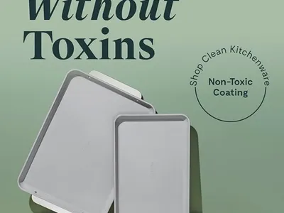 Caraway ceramic-coated baking sheet used for roasting salmon sweet potato cakes, featuring a nonstick surface and durable design for easy cleanup.