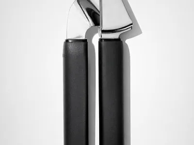 Stainless steel garlic press with ergonomic handles for healthy family meal prep, postpartum cooking, freezer meal preparation, and quick weeknight dinners.