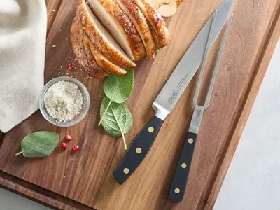 Sur La Table large walnut wood cutting board with deep juice groove, ideal for meal prep, carving roasted meats, food presentation, and family meal preparation.