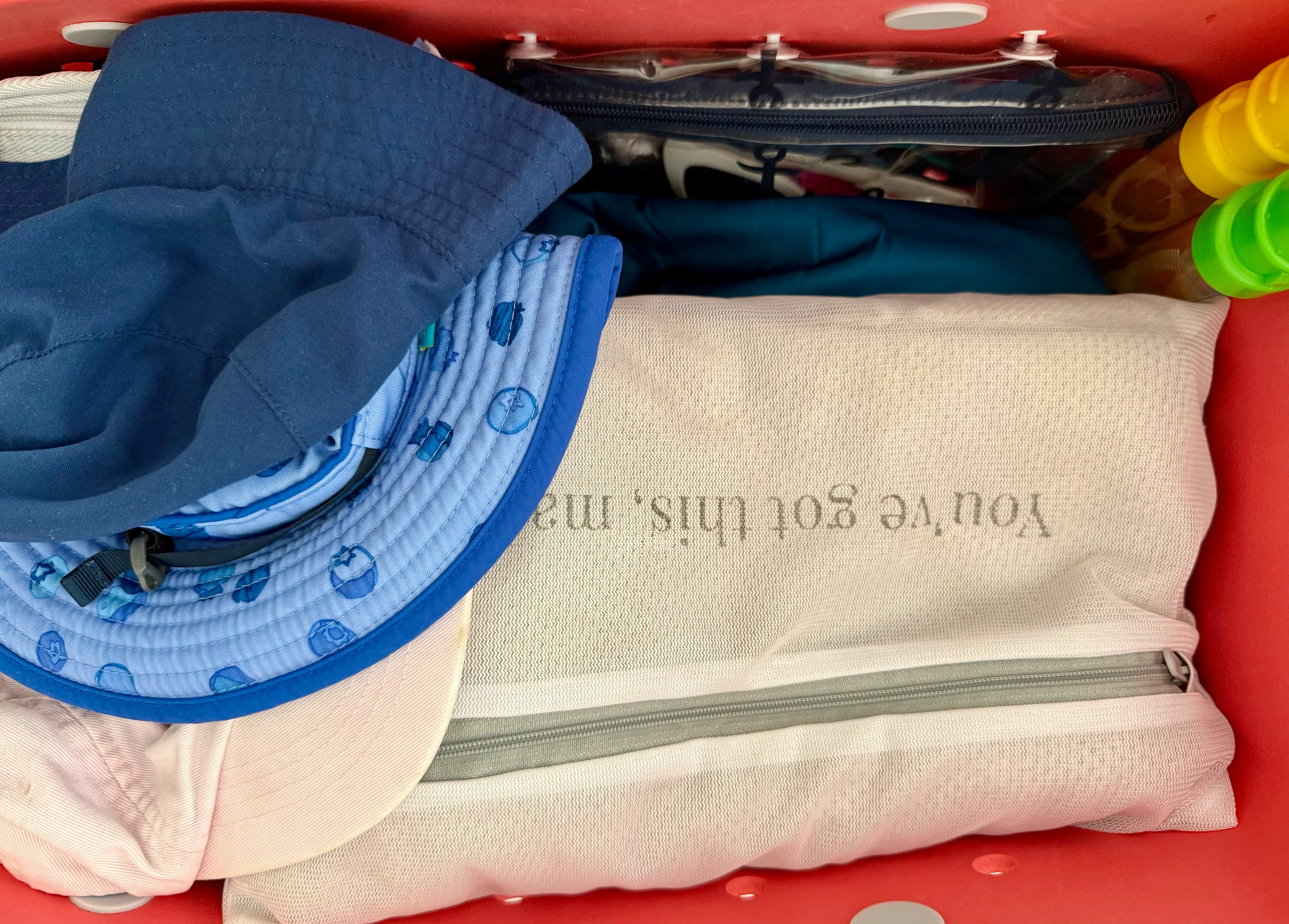 Bogg Bag packed with sun hats, wet dry bag, change of clothes, and nursing cover.
