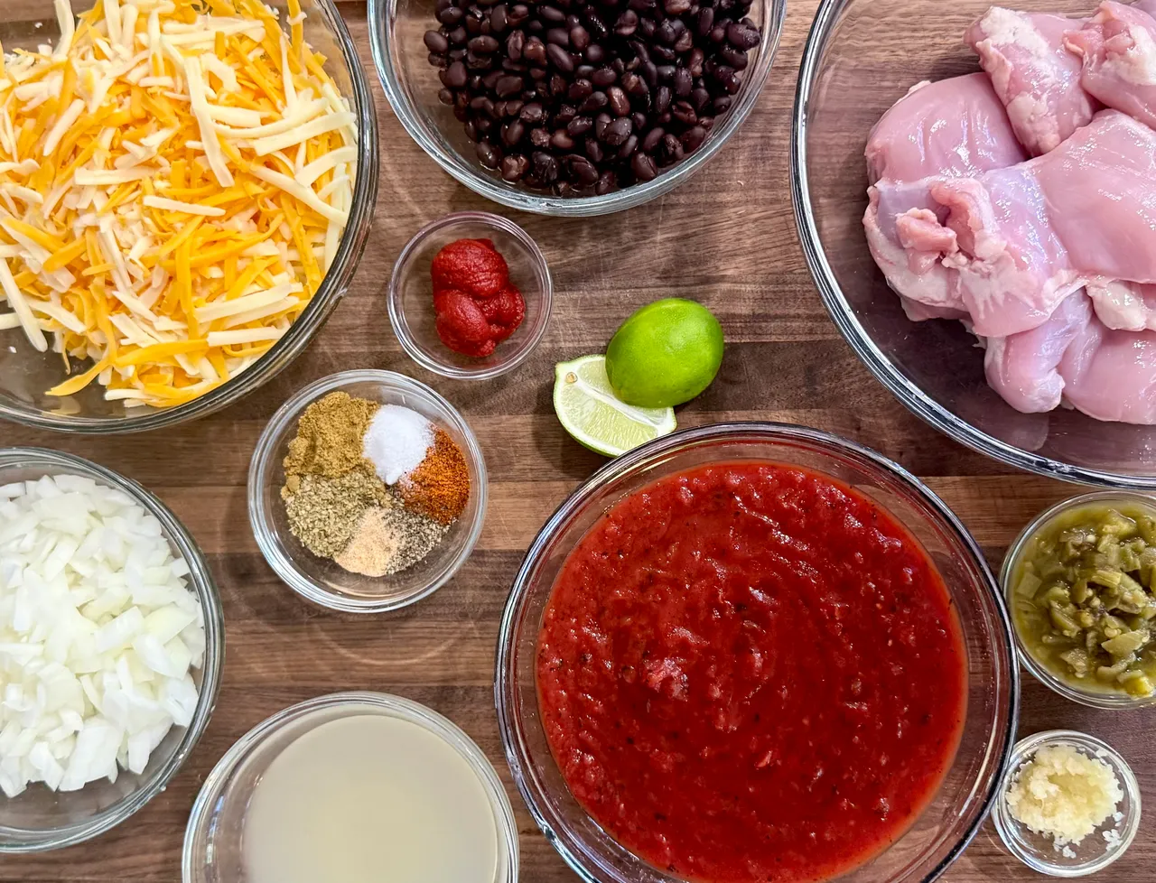 Chicken thighs, black beans, cottage cheese and other ingredients for a chicken enchilada bake