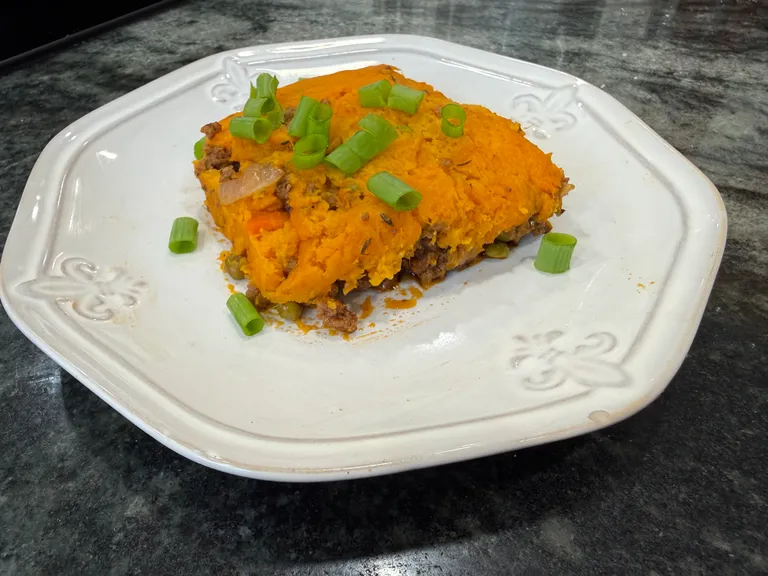 Homemade shepherd's sweet potato pie with seasoned ground beef, vegetables, and creamy mashed sweet potato topping, perfect for postpartum freezer meal prep and healthy family dinners.