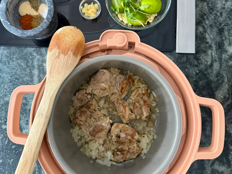 Browning chicken and onions for white chicken chili in a multi cooker, the first step in making this high-protein freezer meal for busy families.
